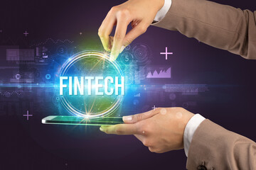 Obraz premium Close-up of a touchscreen with FINTECH inscription, new technology concept