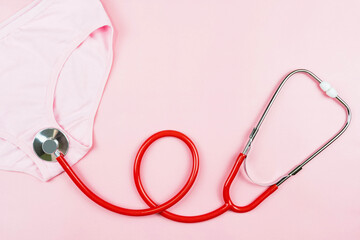 Pink underpants and red stethoscope  isolated on pink background.