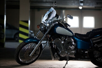 Fototapeta na wymiar A chopper motorcycle silhouette. Motorbike standing in dark underground garage, back light