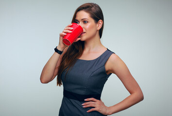 portrait of woman in business dress drinking coffee with red cup.