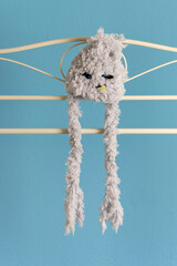 baby monster hand knit hat handing on boutique rail 