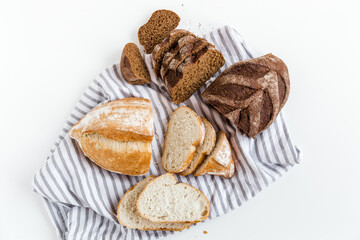 White and brown bread.Homemade freshly baked bread.Healthy food.Whole and sliced bread.White background.Top view.