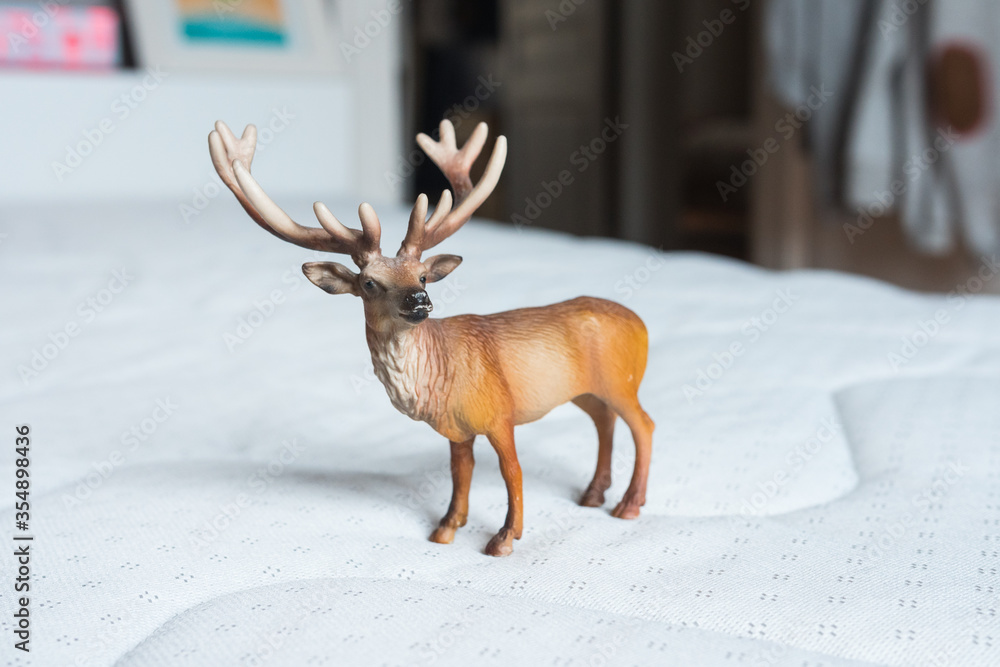 Wall mural beautiful standing up reindeer/stag miniature toy made of rubber or plastic. perfect animal toy for 