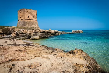View of a cove of the Cinisi coast with ancient watchtower.