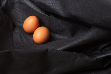 Eggs on black fabric background