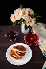 Pancakes with jam. Photo of a glass of tea and pancakes.