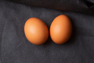 Eggs on black fabric background