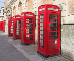 a line of typical old fashioned british red public telephone boxes outside the former post office in Blackpool Lancashire