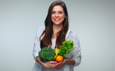 Smiling woman holding healthy green food.