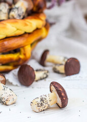 Cookies mushrooms glazed in white and brown chocolate in wicker basket of dough. Dessert. Beautiful sweet