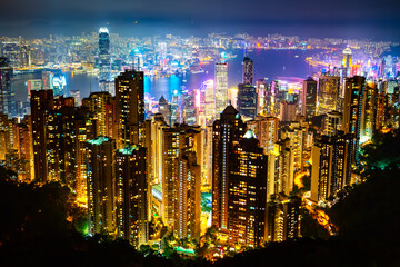 Hong Kong skyscrapers skyline cityscape view from Victoria Peak illuminated in the evening. The most famous view of Hong Kong at twilight sunset. Hong Kong, special administrative region in China.
