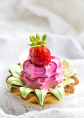 close-up beautiful delicious cupcake with strawberries, pink and light cream