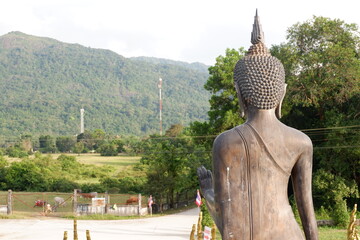 Copy space of backside of buddha statue with sunlight reflection on surface. Vintage tone color...