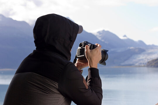 A young man takes pictures in Alaska