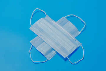 The surgical mask is a cross with the letter X on a blue background. Mask from viruses