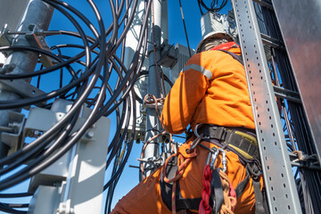 Cell phone installers work on the tower