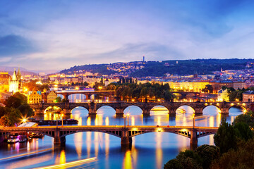 Fototapeta na wymiar Evening cityscape view of bridges on Vltava in Prague, Czech Republic at colorful twilight sunset.