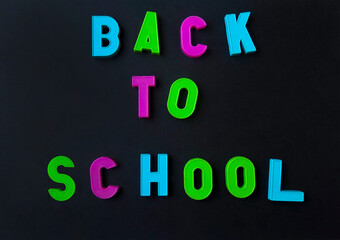 Back to school colorful alphabet letters on the black background.
