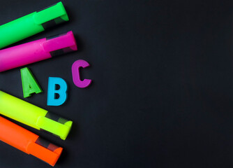 Colorful text selectors with colorful abc letters on the black background. Free space for text. Copy space.