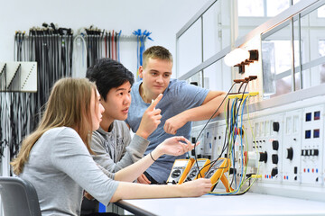 group of young students in vocational education and training for electronics - 354907216
