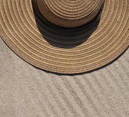 Fototapeta na wymiar Hat and sun cream protection on sand, Summer time concept.