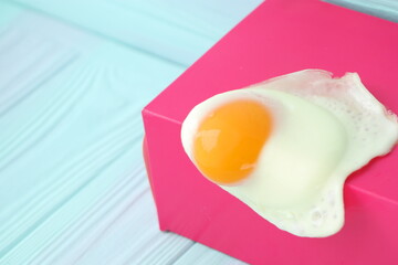 creative fried egg on bright background