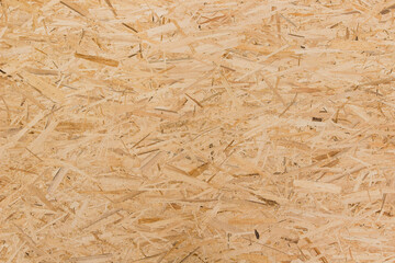 Pressed wooden osb panel. The texture of the plywood panel.