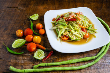 Thai food  papaya salad on a wooden table