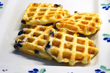 Plate of freshly baked blueberry yeasted waffles for breakfast