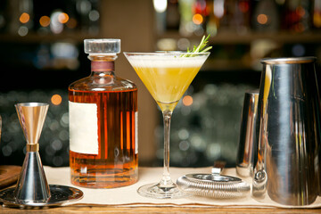 An exquisite Duke Tulip cocktail On a wooden tray. Against the background of a restaurant