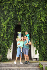 Fototapeta premium Happy loving family with two children, son and daughter playing and hugging. Family walk. Happy Mothers day.