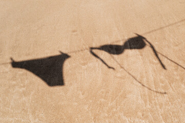 bikini hanging on a clothes line on the beach