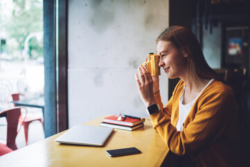 Young woman updating playlist on media application 
