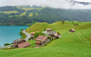 Fototapeta na wymiar Landscape panorama with green nature in Lungern / Lungernsee lake, Swiss Alps, canton of Obwalden, Switzerland