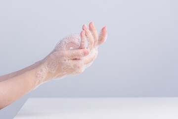 Washing hands. Asian young woman using liquid soap to wash hands, concept of hygiene to protective...