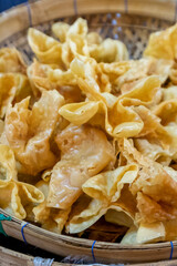 Pangsit Goreng or fried Wonton or fried dumpling crispy. Filled with chicken or shrimp and served with chilli sauce.