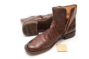 Two brown shoes with untied laces on a white isolated background