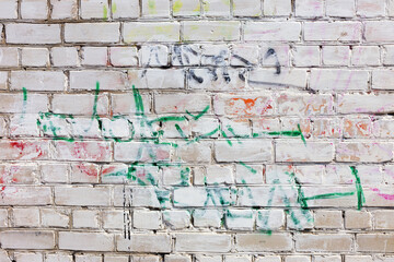 Bullies stained facade of the old building, requires urgent repairs. Landscape style. Grungy concrete surface, windows with bars. Great background or texture.