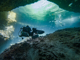 Photo Of A Scuba Diver Swimming On Tropical Crystal Clear Water In A Cave At Sunny Summer.