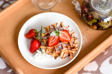 Delicious fresh baked belgian waffles with berries and fruit