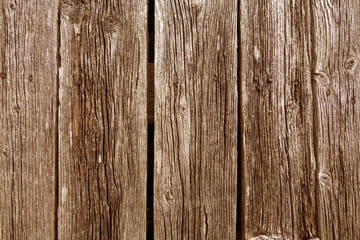 Brown colored weathered rustic wood planks with nails.