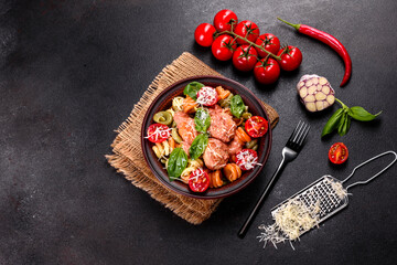 Delicious fresh pasta with meatballs, sauce, cherry tomatoes and basil