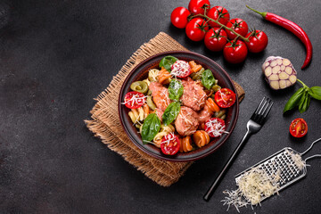 Delicious fresh pasta with meatballs, sauce, cherry tomatoes and basil