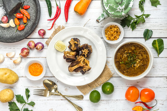 Oxtail Soup And Fried Oxtail Are Served On The Table Side By Side With The Basic Spices.