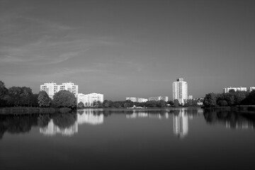 Residential buildings on river bank. Black and white