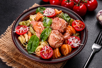 Delicious fresh pasta with meatballs, sauce, cherry tomatoes and basil