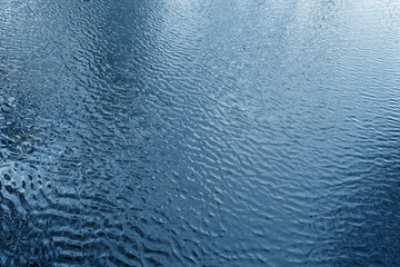 Waves on lake water from top.