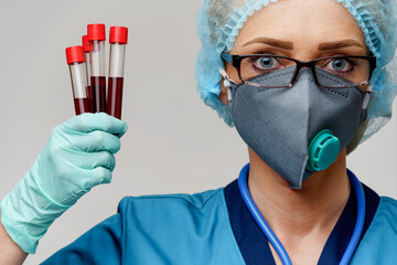 medical doctor nurse woman wearing protective mask and gloves - holding virus blood test tube