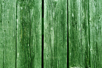 Green colored weathered rustic wood planks with nails.