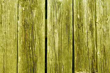 Fototapeta na wymiar Weathered rustic wood planks with nails. Yellow toned